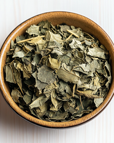 aviv8941_Dried_lovage_leaves_in_a_bowl_on_a_white_background_ta_c62f5441-d85b-483e-8974-db8968bee951