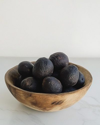 aviv8941_Small_black_Persian_lemon_in_a_wooden_bowl_on_a_table__3354b749-2b5a-4b1e-b9b6-9af698c9fa42 copy